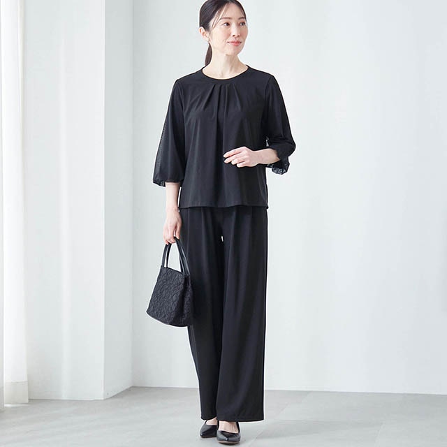 チュールをふんわり重ねた七分袖や、胸元のタック使いがエレガント