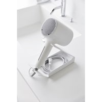 電源コードは、まとめてトレーに収納できます。